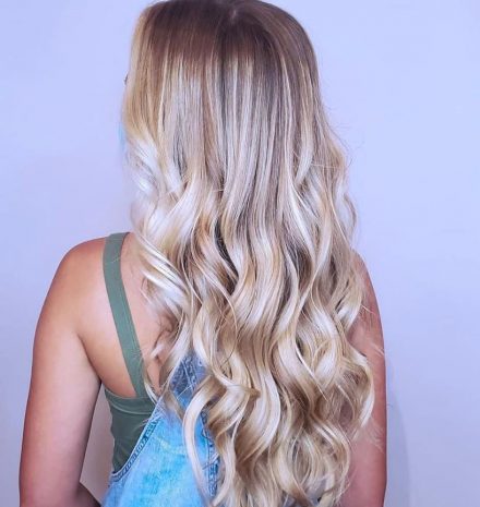 Back of woman's hair showing off blonde balayage highlights