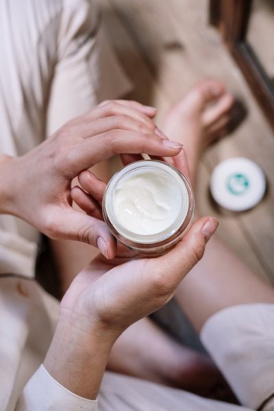 Ideal Skincare Routine for Different Skin Types Downward view of woman holding skin moisturizer
